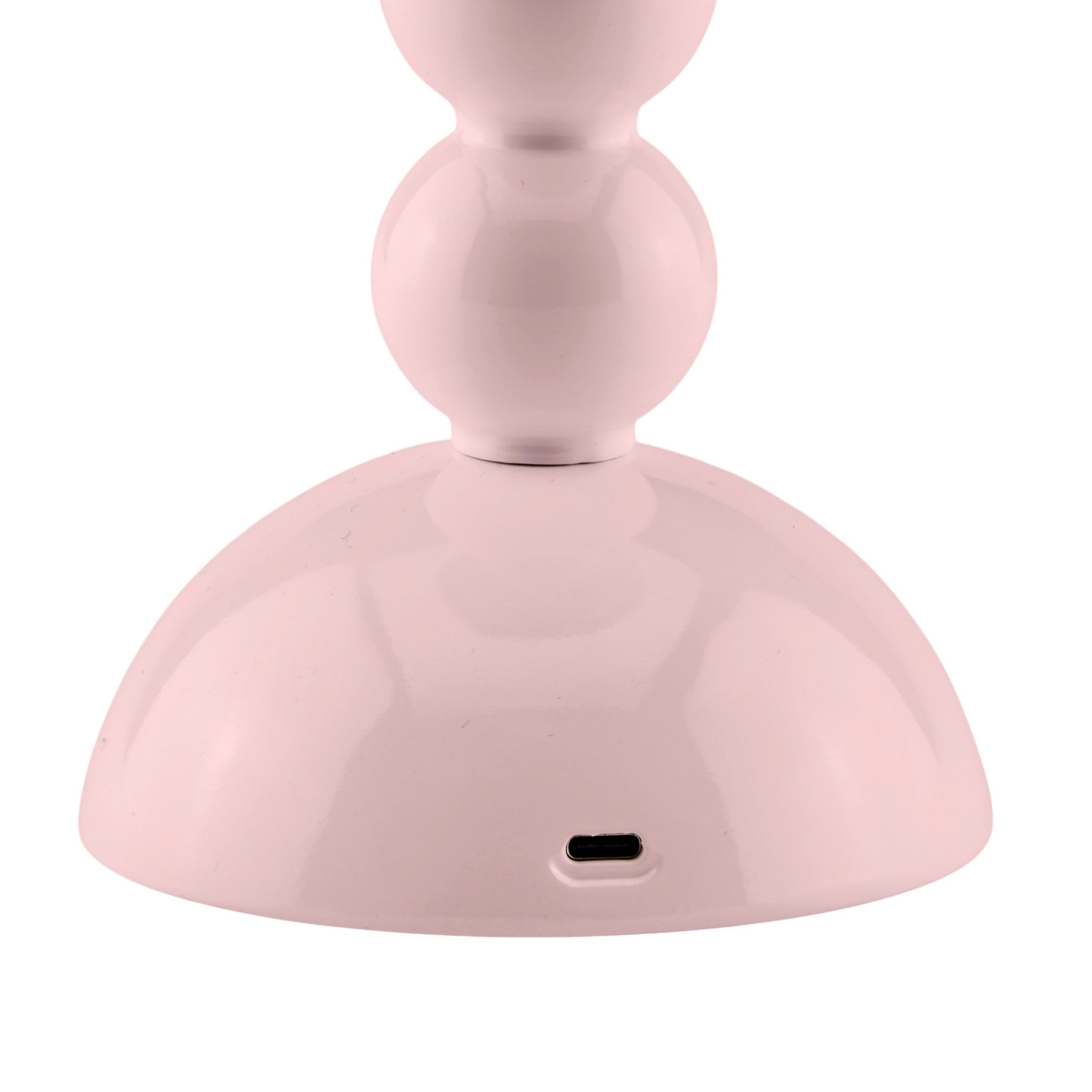 Een close-up van de Addison Ross Bobbin Lamp LED Oplaadbaar Roze toont de lichtroze, afgeronde voet met een USB-C poort-perfecte sfeerverlichting, geïnspireerd op het elegante draadloze ontwerp van Addison Ross.