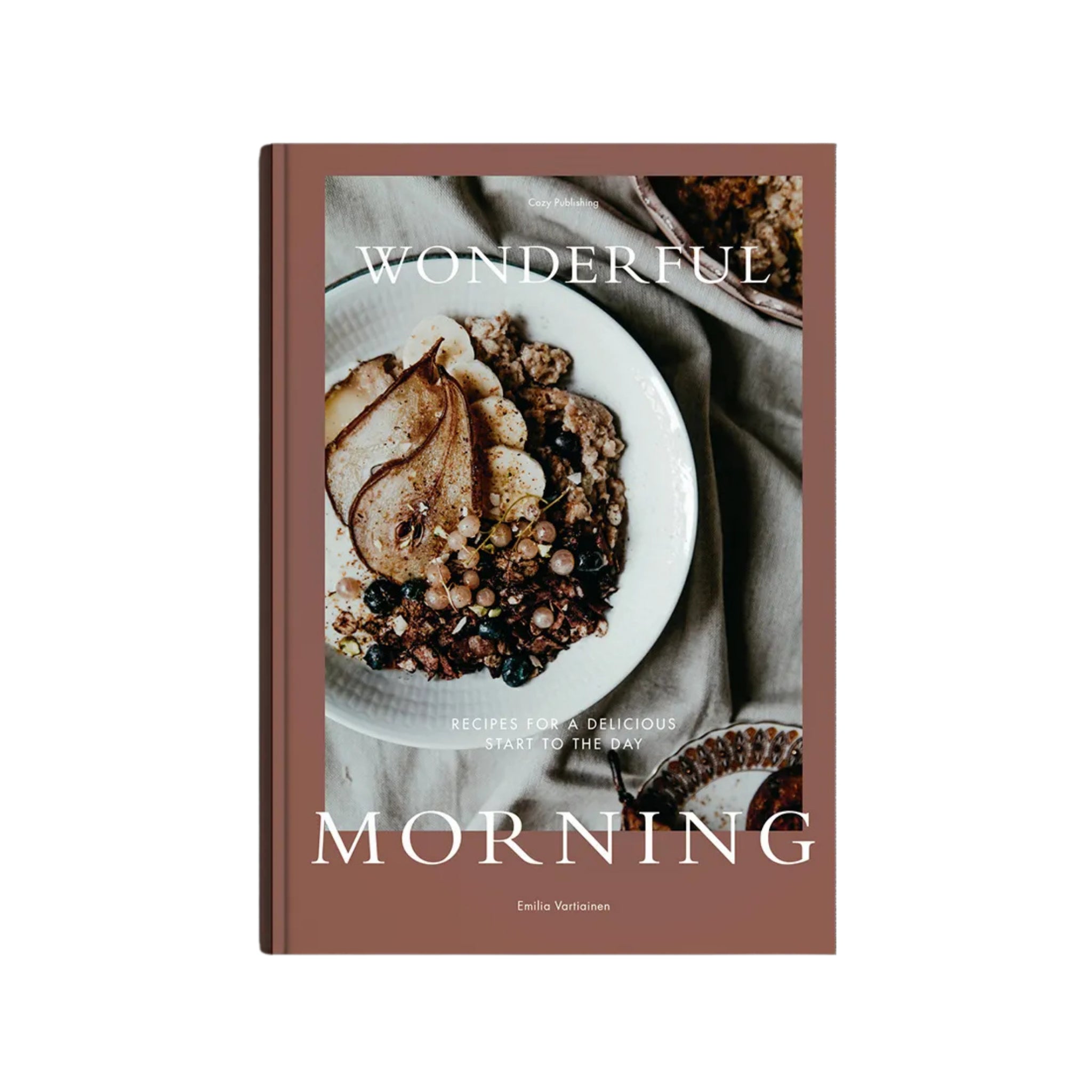 Op de cover van het Cozy Publishing Wonderful Morning Kookboek staat een witte kom met granola, peren en bessen. De ondertekst luidt "Ontbijt recepten voor een heerlijke start van de dag." Merk: Cozy Publishing.