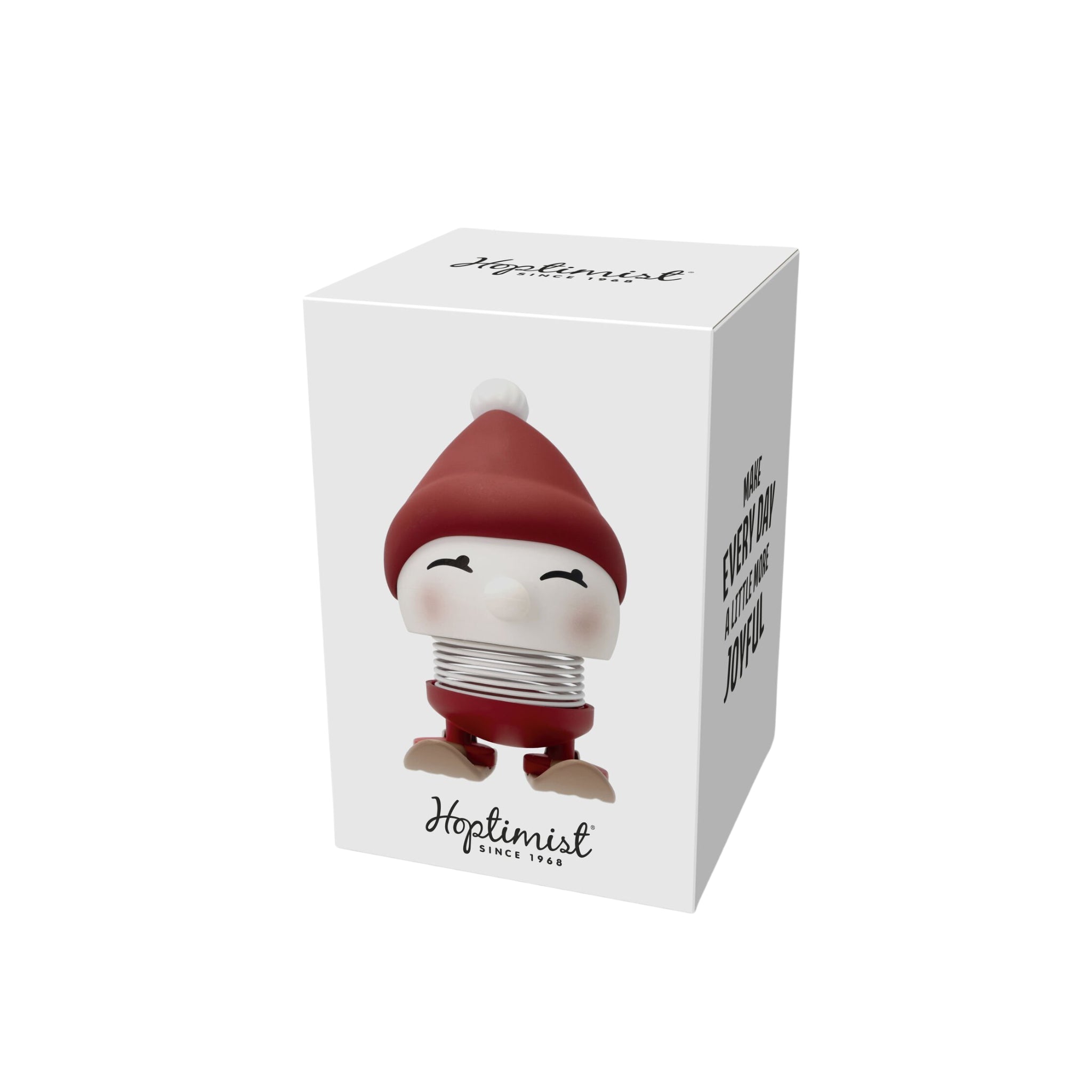 Op een witte doos staat de Hoptimist Ski Bimble S Berry van Hoptimist - een rood-wit beeldje met een lachend gezichtje, ronde neus en veerkrachtig lichaam. Op de verpakking staat "Hoptimist" en "Make Every Day More Joyful"-perfect als winterdecoratie of uniek cadeau.