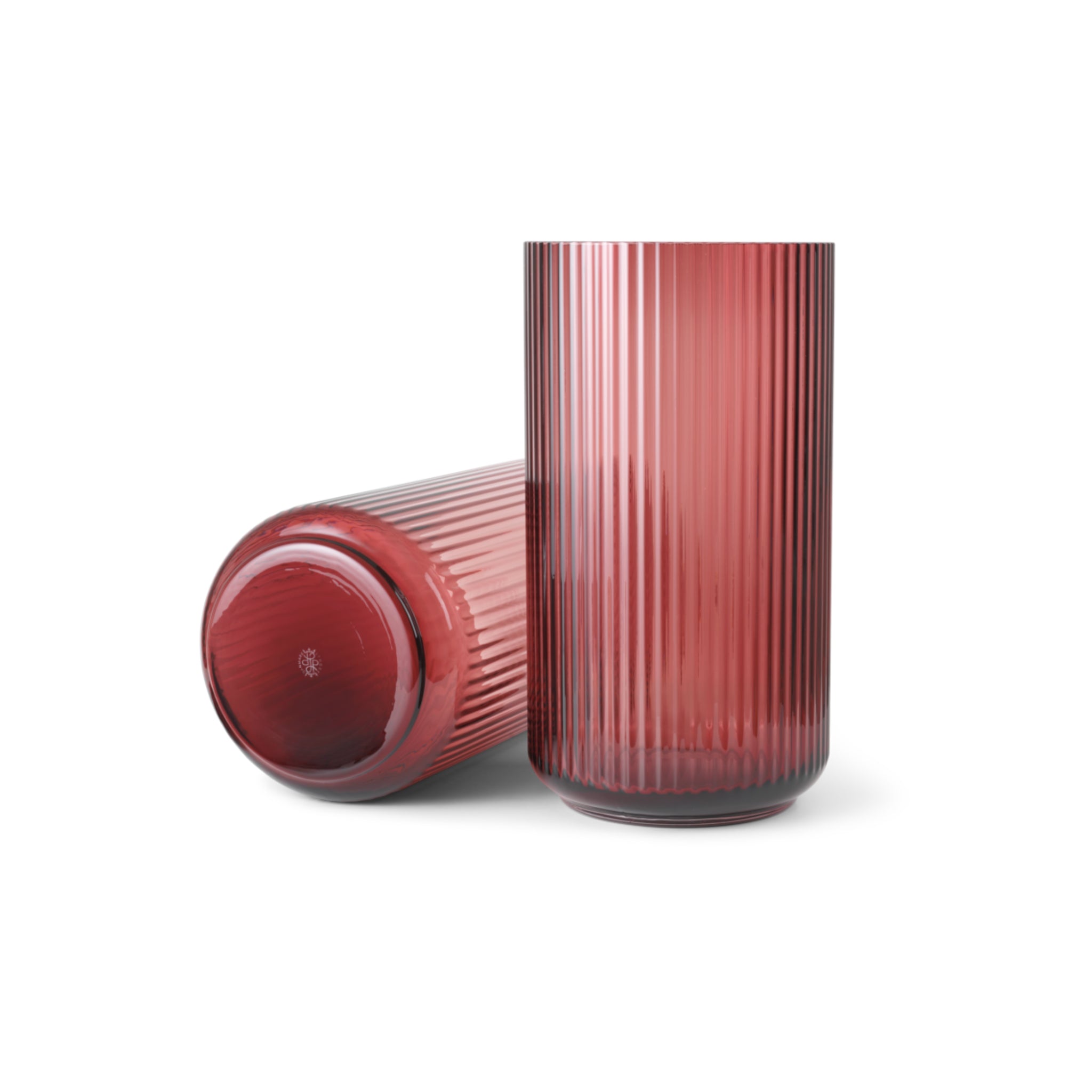 Twee geribbelde, cilindervormige Lyngby Porcelaen Vaas Bordeaux H38 vazen - een rechtopstaand, een liggend - staan naast elkaar op een effen witte achtergrond.