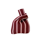 Een kleine stoffen Caro Antwerp handtas, de Caro Handtas Double Dash Pink Promise, heeft kastanjebruine en witte verticale strepen met een geknoopt handvat - perfect voor je Pinky Promise momenten.