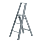 De Hasegawa Lucano Ladder 3 Step Grijs van Hasegawa, geïnspireerd op Japans design, is een zilverkleurige opvouwbare ladder met drie treden en een handgreep bovenaan, afgebeeld tegen een effen witte achtergrond.