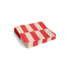 Een stapel Hay Pattern Papieren Servetten Off-White Rood 33/33 van Hay, met een rood en wit geruit motief, netjes gerangschikt tegen een witte achtergrond.