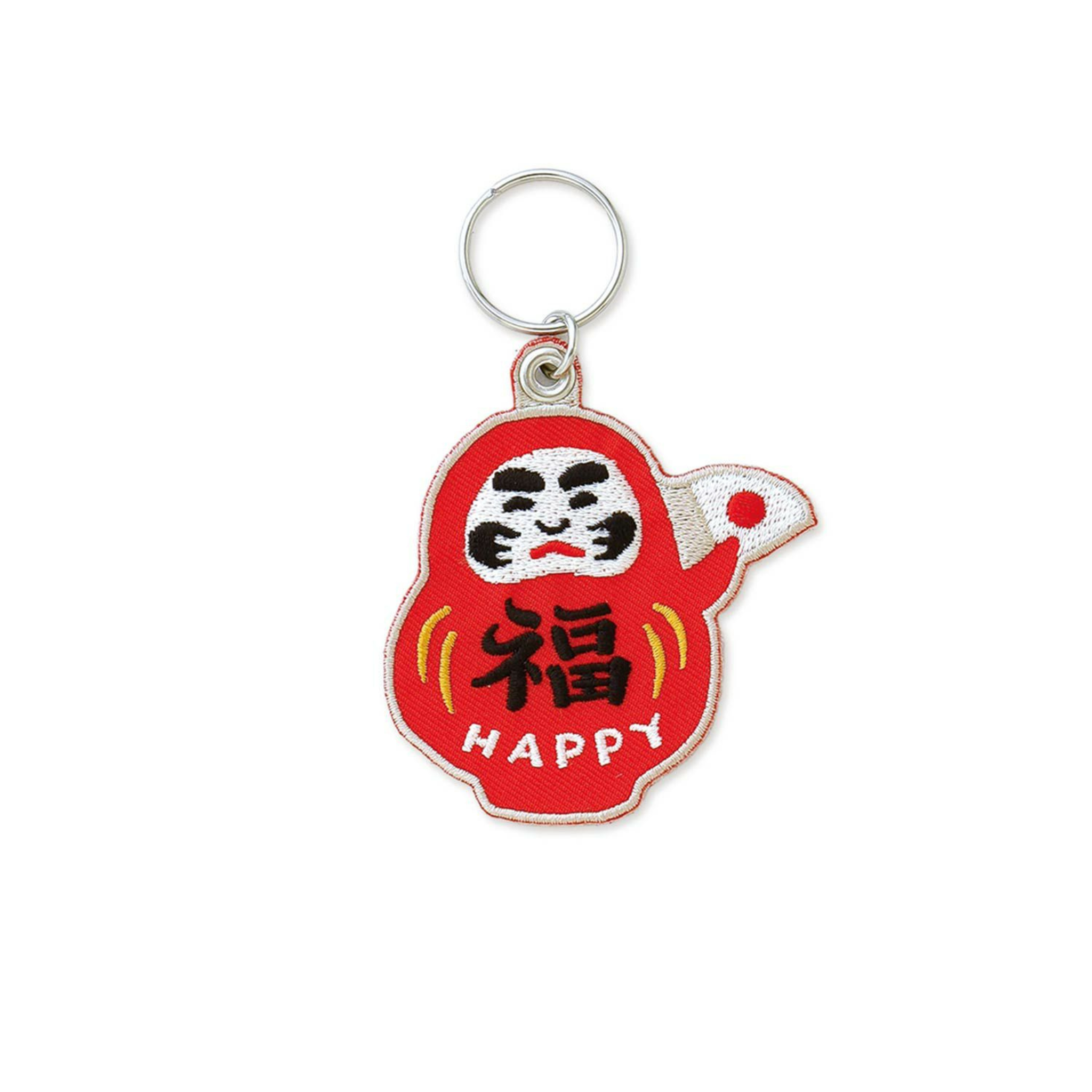 De Hightide Stitch Work Sleutelhanger Daruma van Hightide heeft een rode Daruma met een lachend gezichtje, zwarte wenkbrauwen, "HAPPY" onder een gele kanji, opgeheven rechterarm en een sleutelhanger bovenop-een charmant Japans symbool.