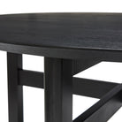 Close-up van de Hubsch Fjord Eettafel Essenhout Zwart D120: een zwarte ronde houten tafel van Hubsch, met stevige poten en kruisende steunbalken eronder.