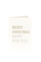 Een crèmekleurige Matriks Kerst- en Nieuwjaarskaart Vrolijk Kerstfeest Gelukkig Nieuwjaar staat rechtop, de feestelijke groet vetgedrukt op de voorkant-een perfecte kerstgroet en nieuwjaarswens van Matriks tegen een effen witte achtergrond.