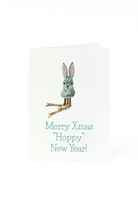 Op de Matriks Kerst- en Nieuwjaarskaart Merry Christmas Hoppy New Year! van Matriks staat een blauw konijntje met roze oren en gouden pootjes boven de tekst "Merry Xmas Hoppy New Year!" op een effen witte achtergrond.