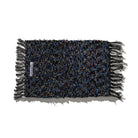 De Puebco Mat Gerecycleerd Textiel 63/41 is een rechthoekige mat van Puebco met veelkleurige blauwe, zwarte en gouden draden en gefranjerde randen, plat uitgelegd op een witte ondergrond.