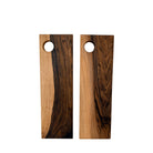 Twee Weshwood Serveerplank Europese Notelaar 15/47 planken, elk met unieke houtnerf en een rond gat in de linkerbovenhoek, worden naast elkaar weergegeven op een witte achtergrond. Merk: Weshwood.