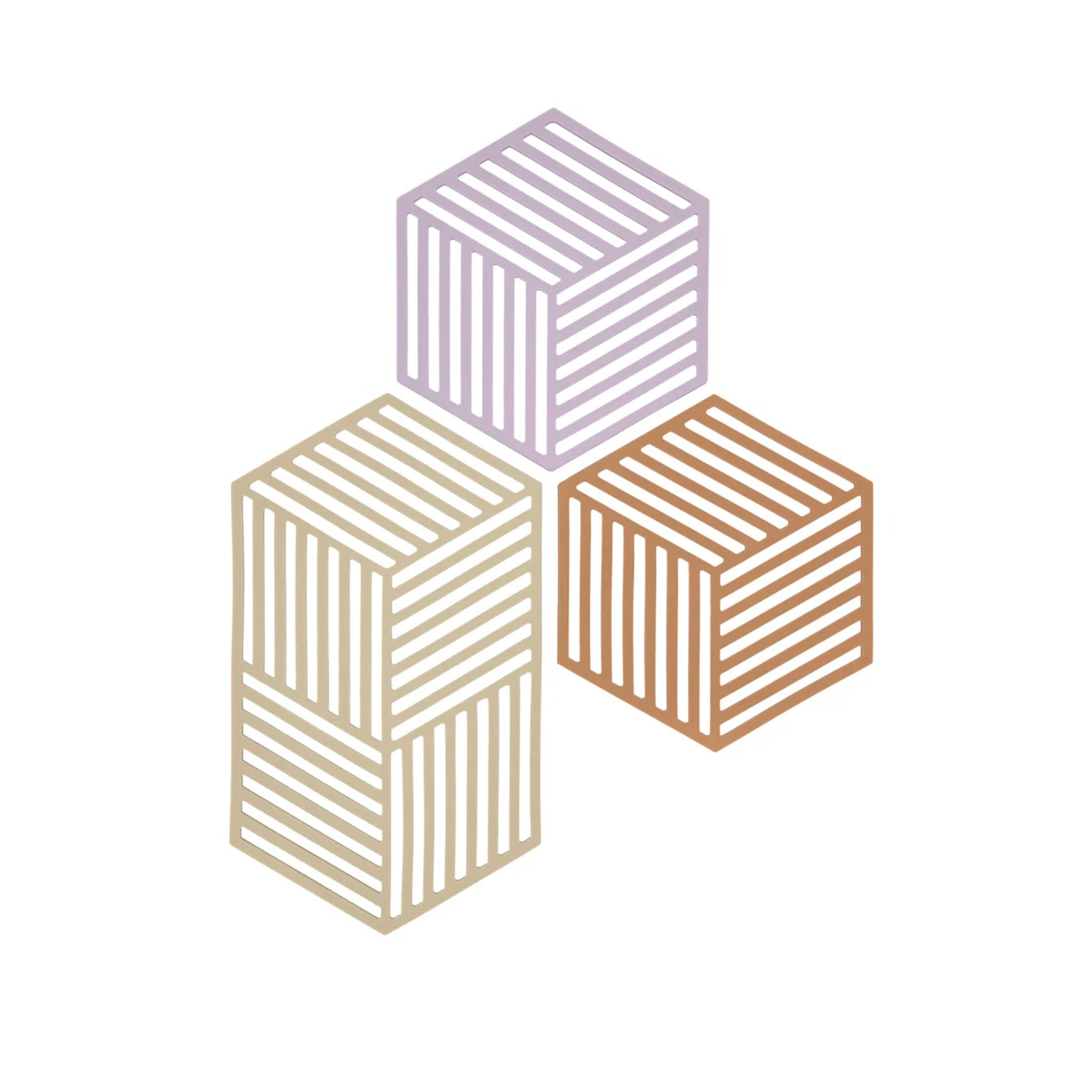 Drie gestreepte kubussen in pastel lavendel, beige en oranje zijn gestapeld op een witte achtergrond en weerspiegelen de moderne Deense stijl - ideaal als speels accent naast je Zone Denmark Hexagon Trivet Lupine.